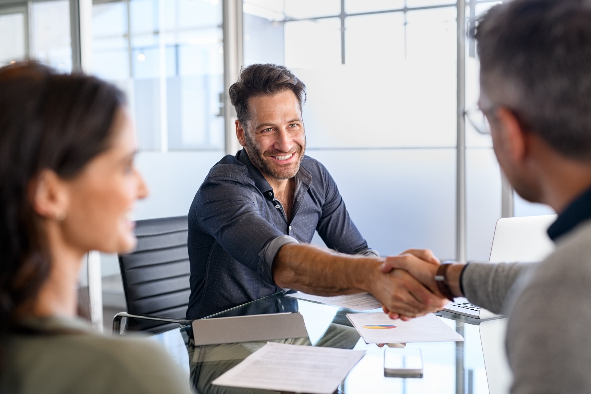 A financial consultant pointing at a screen or explaining something to a customer.